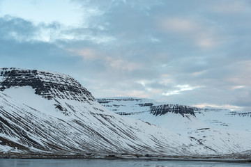 Fjords covered in snow and ocean seashore