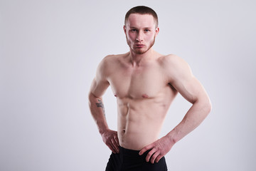 Fototapeta premium serious muscular man shoing his body