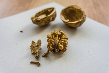 Broken walnut eating on the kitchen table, rich in protein, fat, iron, phosphorus, magnesium and other mineral salts, B-group vitamins and a whole range of trace elements. Shallow depth of focus.