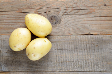 Fresh potato on wooden table top view