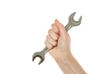 Vintage wrench in a female hand is isolated on a white background