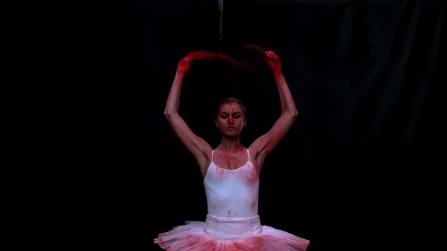 Ballerina performing on black background super slow motion