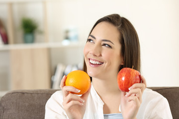 Woman wondering about apple and orange