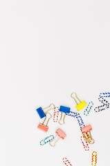 Top view of office accessories, paper clips, on white background with space for your text or photo