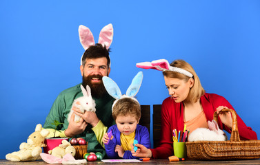 Easter egg, bunny ears - easter day concept. Easter egg decorating happy family.