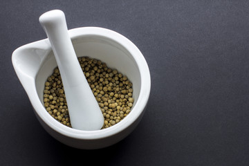 White peper peppercorns in mortar and pestle