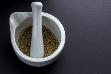 White peper peppercorns in mortar and pestle