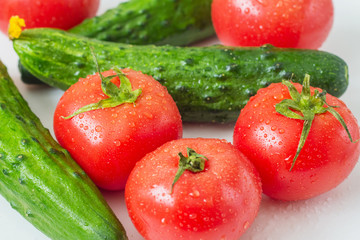 Water drops, tomatoes and cucumbers