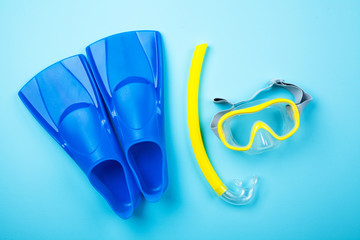 Blue flippers on color background