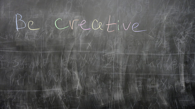“Be creative” sign written by a child on a chalkboard