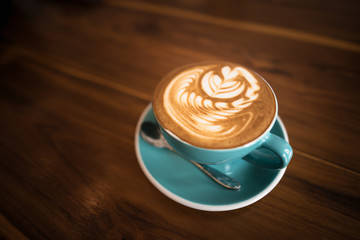 Hot latte coffee on wooden table