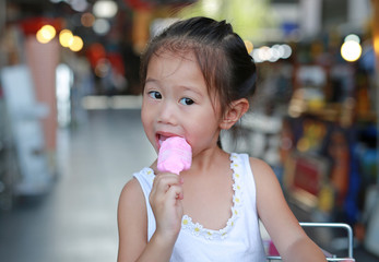 Kid girl enjoy eating ice-cream.