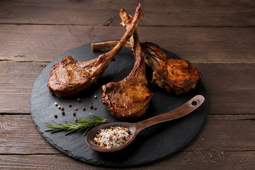 roasted lamb ribs loin chop on a stone surface © koss13