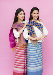 Portrait beautiful Asian girls in traditional Thai dress isolated on pink background. Cotton Dress