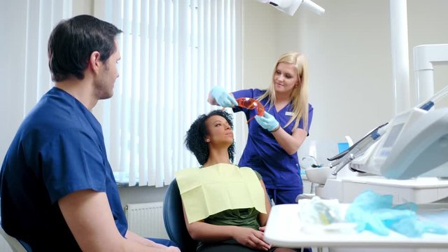 Dentist and his assitant working in private practice.