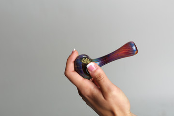 Marijuana pipe in a hand