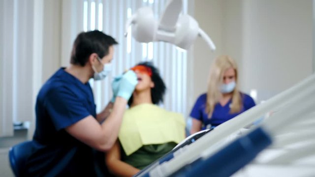 Dentist and his assitant working in private practice.