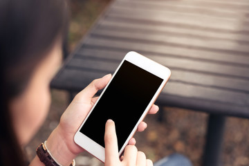 Woman using blank screen smartphone. screen for the graphics. Concepts for Digital Technology in Everyday Life.