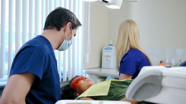 Dentist and his assitant working in private practice.