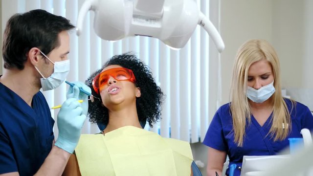 Dentist and his assitant working in private practice.