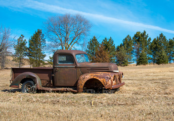 Rusty old truck in field