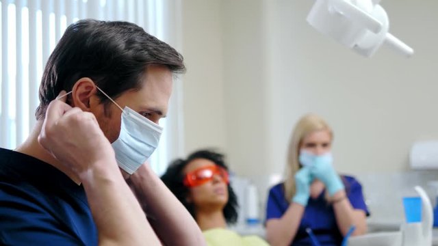 Dentist and his assitant working in private practice.