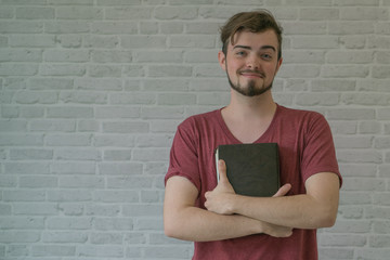 Closeup on a man holding a bible, believe concept