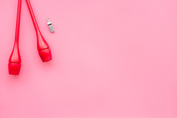 Maces for rhythmic gymnastics on pink background top view copy space