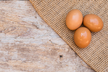 Fresh eggs are placed on old wood