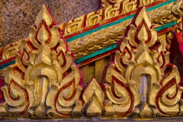 Fototapeta na wymiar Fragment of decoration of Buddhist temples. Decoration of temples in Thailand. Architecture of Thailand. the island of Phuket.