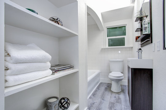 Narrow White Bathroom Interior With Open Shelves