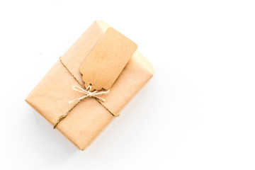 Parcel packaging box wrapped with craft paper with empty label mockup on whitebackground top view copy space
