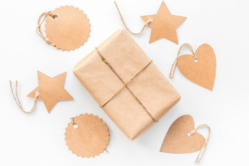 Parcel packaging box wrapped with craft paper with empty label mockup on whitebackground top view