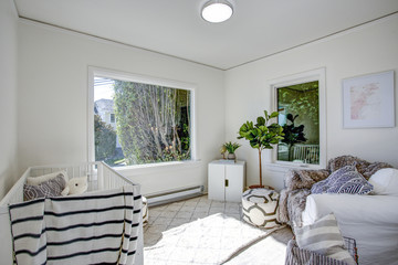 Light Nursery with white walls.