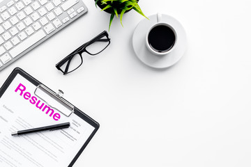 Create resume. Resume on white work desk with coffee, glasses, keyboard top view copy space