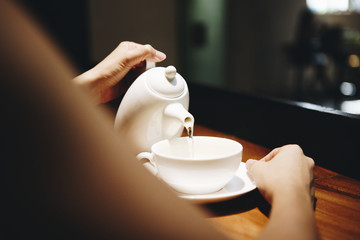 Woman pouring a hot drink