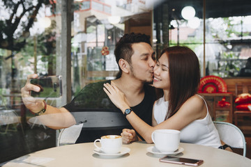 Lovely asian couple having coffee