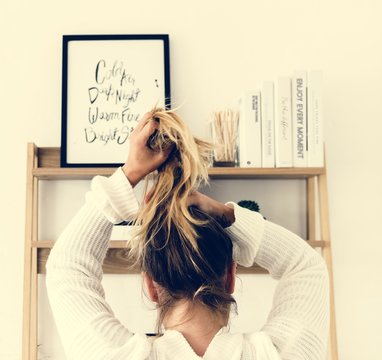 Rear View Of A Woman Tying Her Hair Up