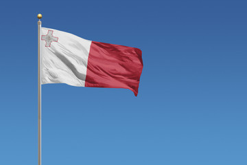 Fototapeta na wymiar Flag of Malta in front of a clear blue sky