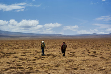 Fototapeta na wymiar Hike Ngorongoro Conservation Area National park Highlands craters en route for Bulati Village from Nainokanoka with Masai Guide and cook.