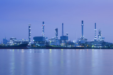 Oil refinery is near the riverside at night in Bangkok.