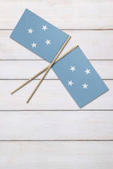 Micronesia Two flags on a painted wood background