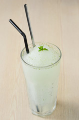 Freshly lemon smoothie in glass bottles with straw and mint leaf