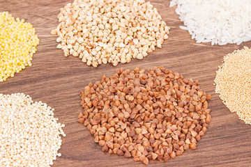 Gluten free white rice and groats on rustic board, healthy food concept