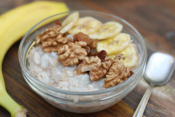 Top view of a Granola Bowl, Muesli with Oats, Nuts and Dried Fruit on Wooden table. Healthy Breakfast. Diet.