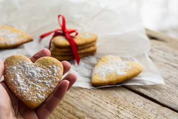 Homemade cookie hearts tied with red ribbon. A gift for a holiday.