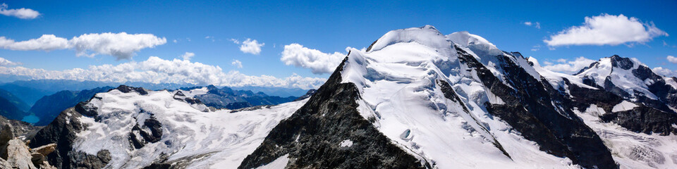 Fototapeta na wymiar panoramic view of the Val Poschiavo and Piz Palu in the Bernina mountains as seen from the summit of Piz Cambrena