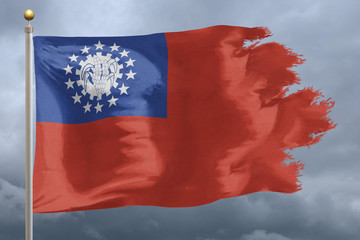 Myanmar Flag with torn edges in front of a stormy sky