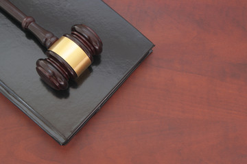 Wooden judge gavel and legal book, law, legal and court concept