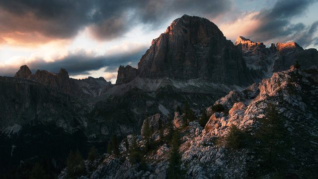 Fototapeta Dramatic sunset in the mountains with dark heavy clouds in Dolomite Mountains Italy
